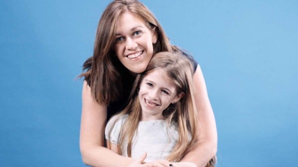 Female Intuit employee smiling with her daughter