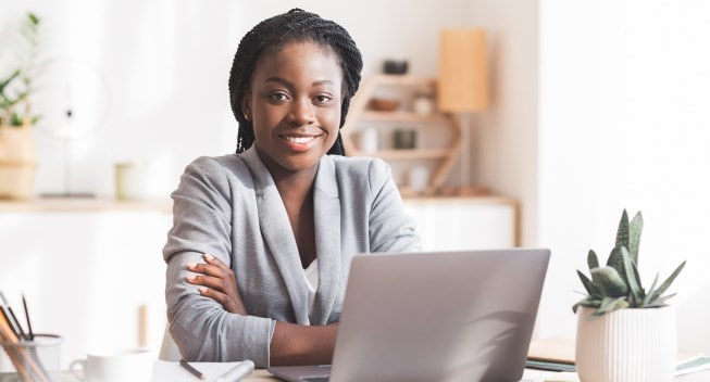 Black employee sitting at her desk