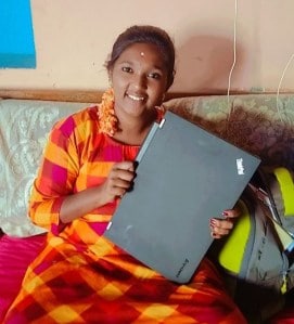 Girl smiling with her computer as part of the Intuit Rise program