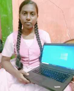 Pavitra and her computer provided by Intuit through the Intuit Rise program