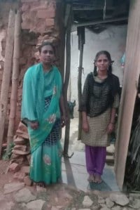Pavitra with her mother in front of their home