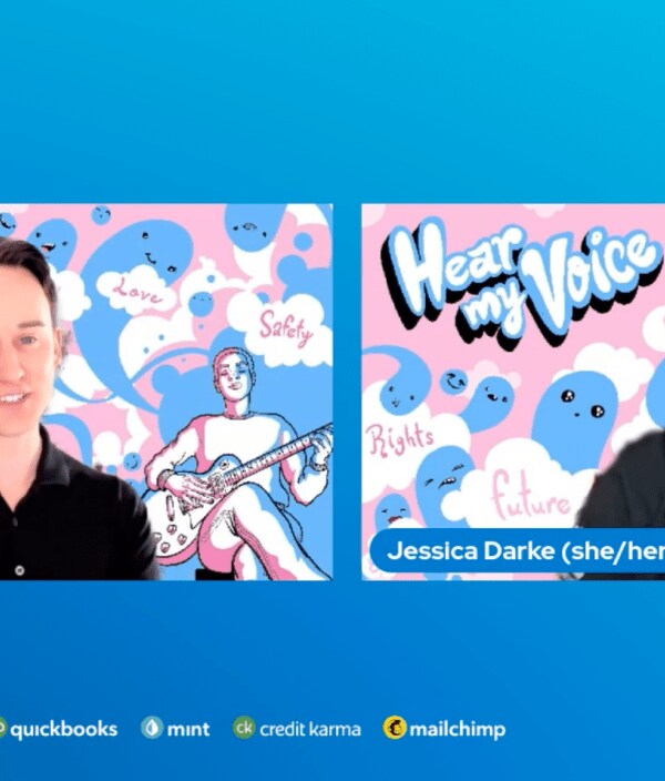 A screen grab of two professionals with pink and blue artwork behind them.