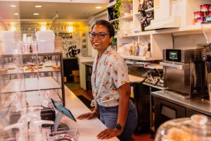 Smiling coffee shop owner.