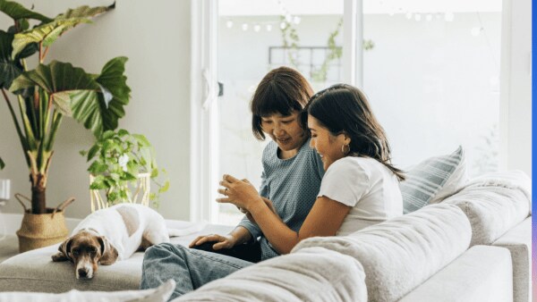 Image from the our 2022 Intuit DEI report with two women sitting on a couch
