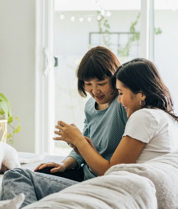 Image from the our 2022 Intuit DEI report with two women sitting on a couch