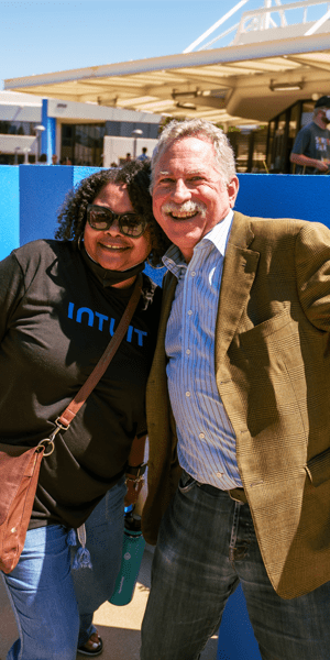 Two Intuit employees smiling at the camera