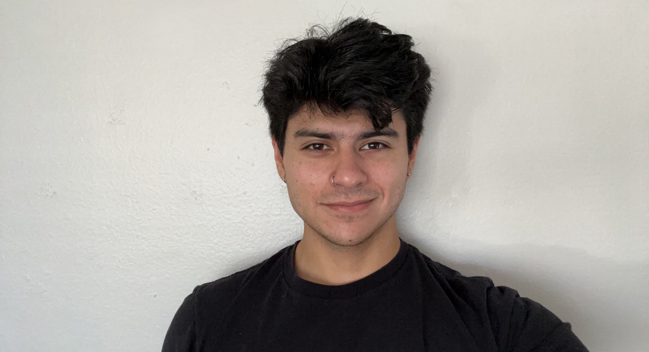 German Flores, an Intuit software engineer smiles for the camera against a white background