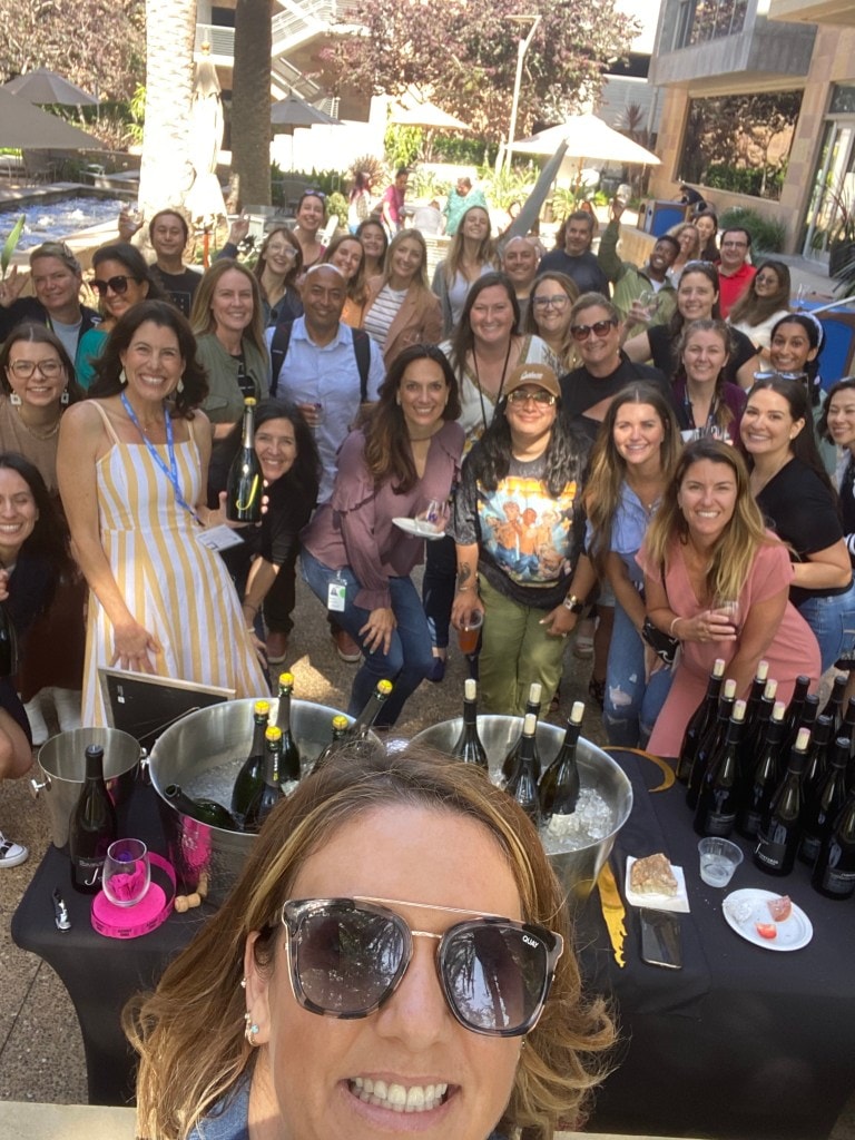 A group of women pose at a wine fundraiser