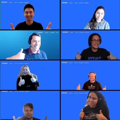A screenshot of 8 employees from a Zoom call with blue backgrounds giving a thumbs up.