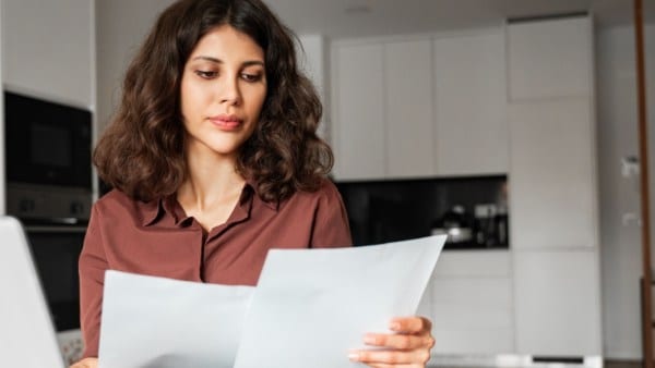 Focused latin hispanic young business woman working on laptop