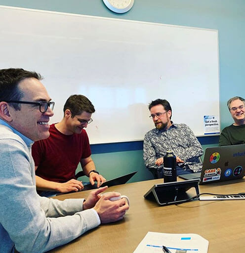 Intuit employees in a meeting room Intuit employees in a meeting room