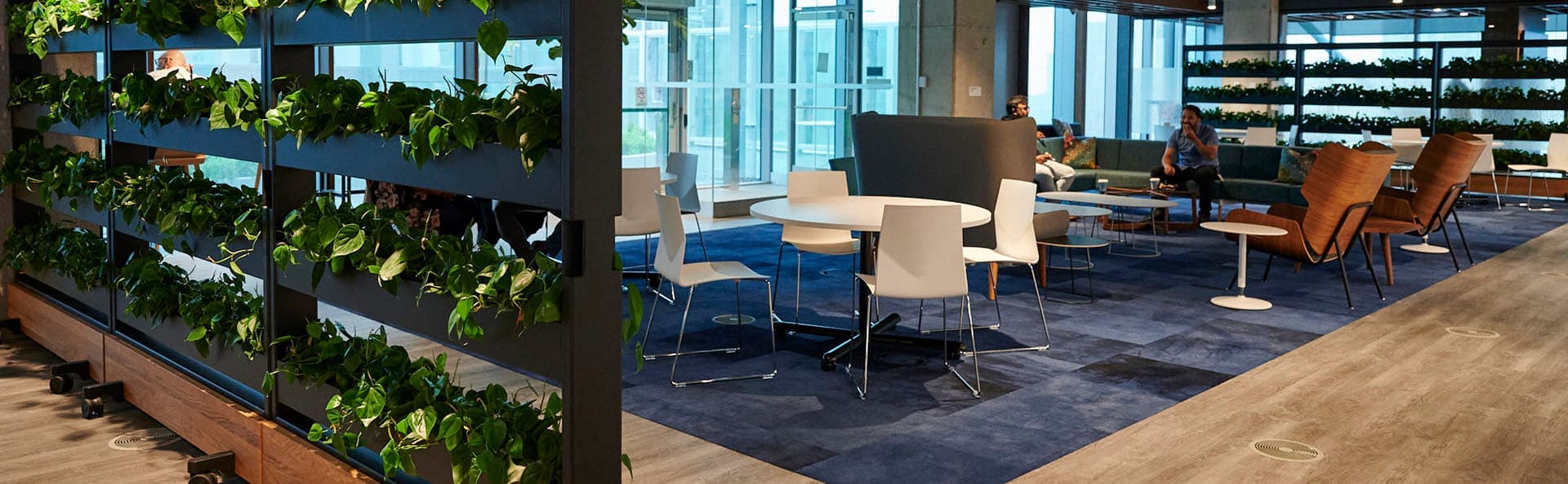 A blue chair sitting in a living room next to a table.