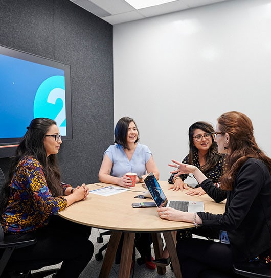 Intuit employees having a discussion in a meeting