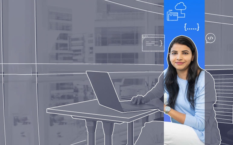 A person is sitting at a desk with a laptop and a desktop computer.
