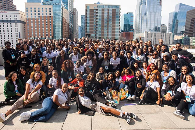 A large group of people sitting on a street.