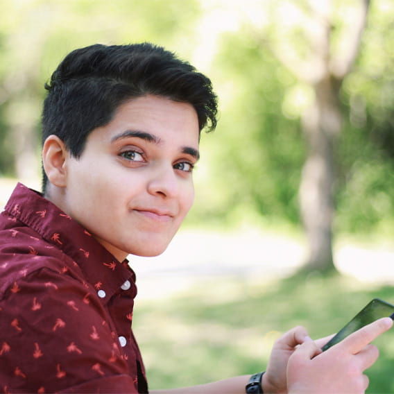 aish-kumar-headshot-photo-icom-desktop-568x568.jpeg A person with a red shirt smiling.