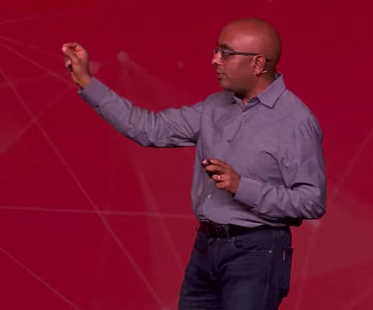 Ashok Srivastava in front of a red background.