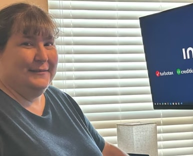 A person sitting at a desk with a laptop.