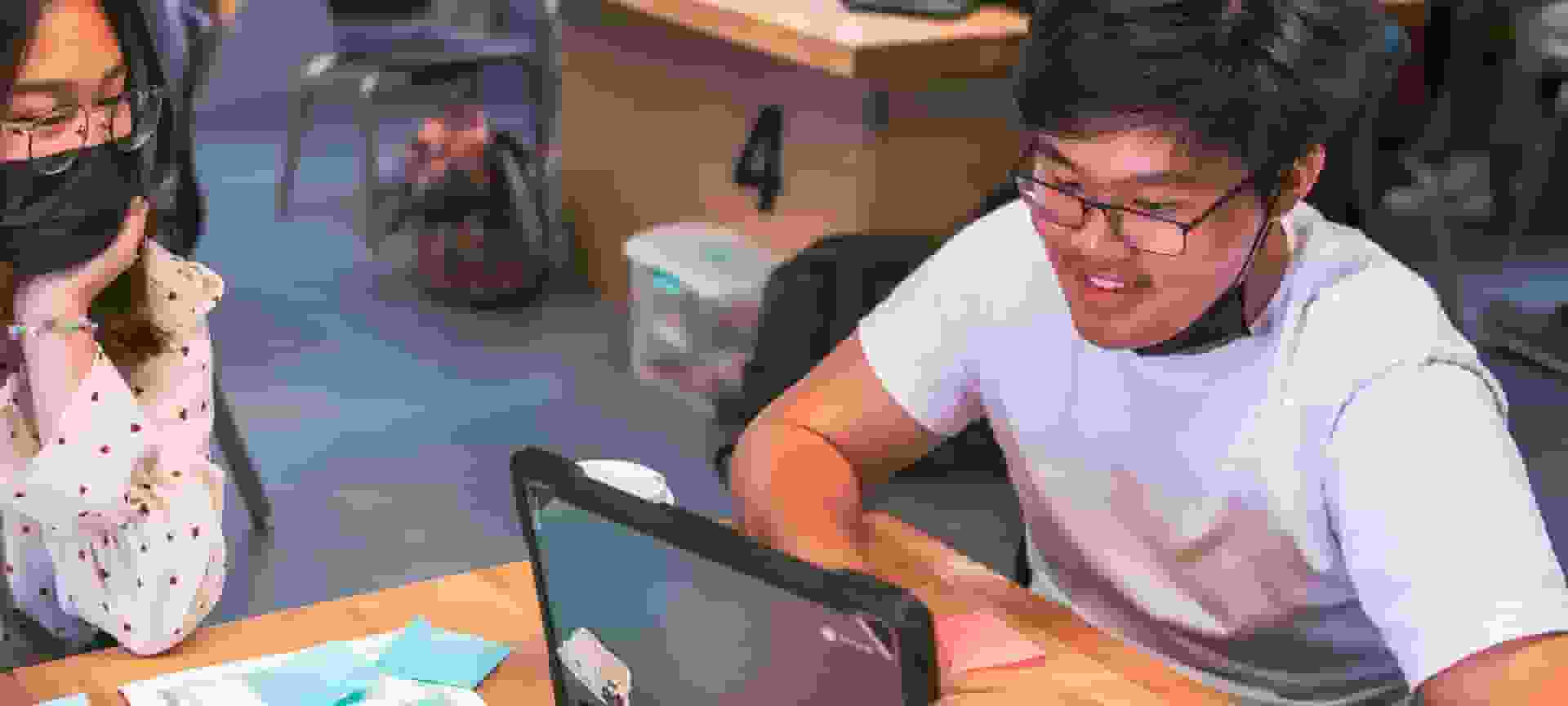 classroom-students-hero-desktop-121222-1920x864.jpg Students in a classroom collaborating