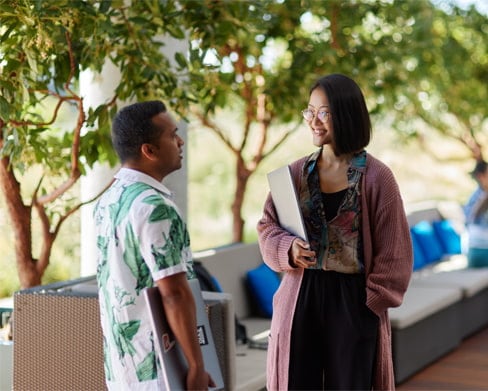 Two colleagues chatting on a balcony. 