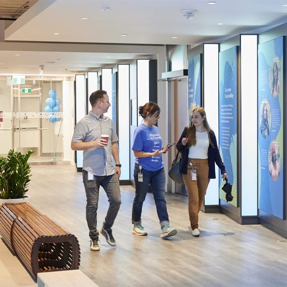 Colleagues walking together in the office hallway