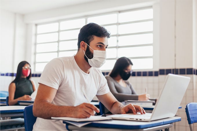 College students wearing face masks in classroom
