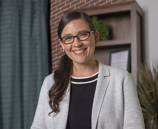 An Intuit Expert, in her home office, smiling. 