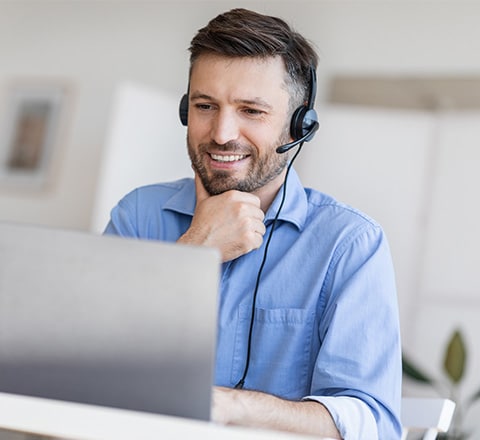 An Intuit Expert, wearing a headset, looking at his computer 