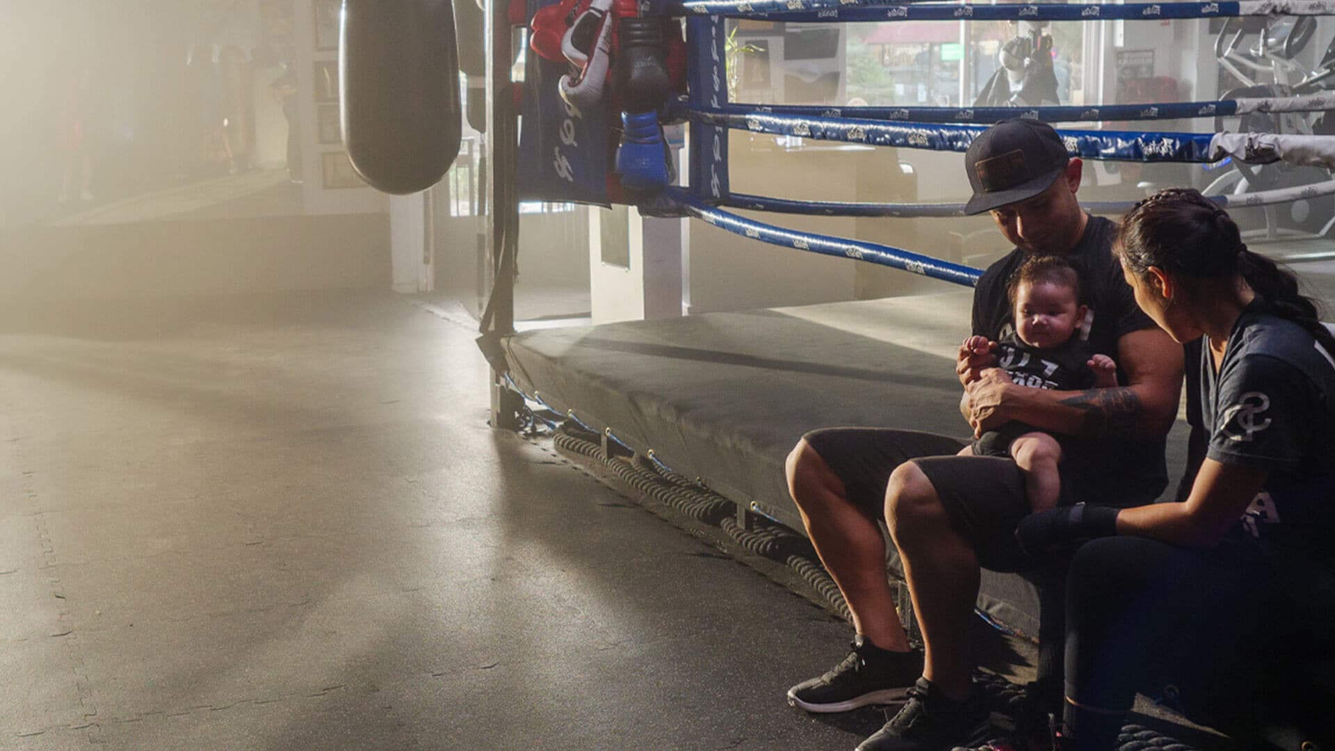 A family sitting by the boxing ring spending quality time