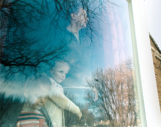 A father and his kids looking out the window