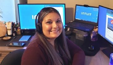 A person sitting at a desk with a computer.
