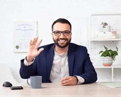 A person sitting at a table with a glass of wine.
