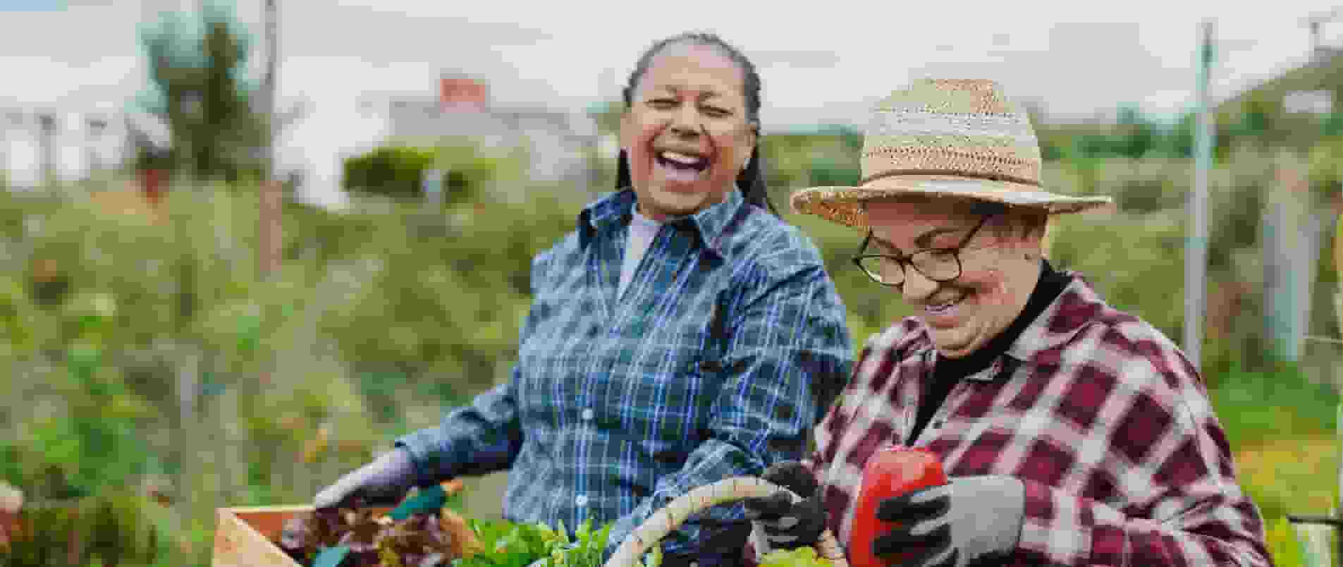 A person holding a flower in her hand while another person looks on.