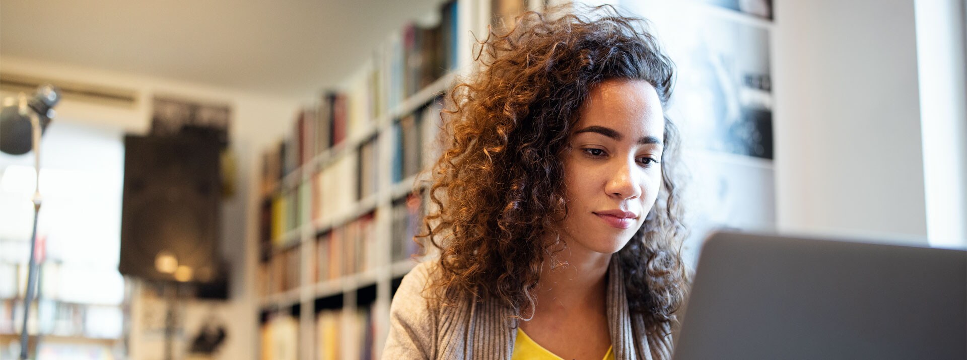 Female student in library using laptop