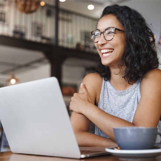 A person sitting at a table with a laptop.