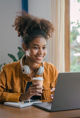 A person sitting at a desk with a laptop.