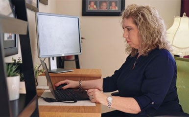Sarah working using a laptop