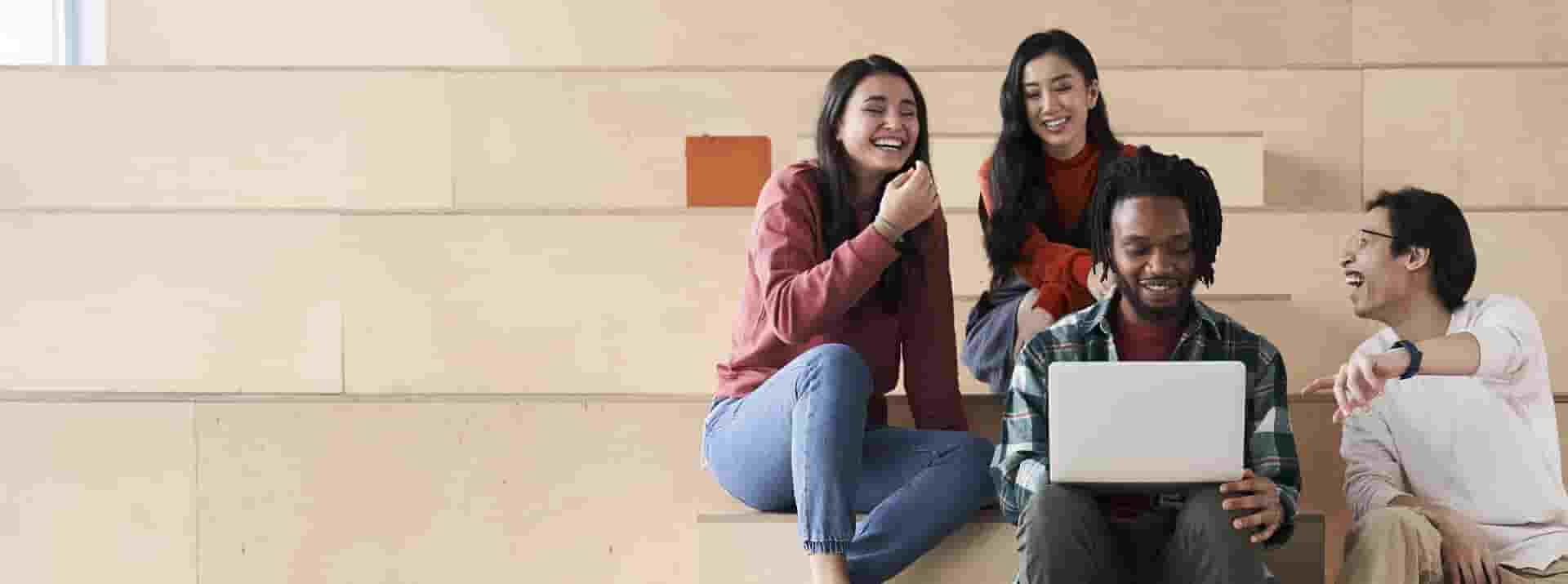 diverse-classmates-having-fun-photo-icom-desktop-1920x534.jpg Four diverse classmates having fun and laughing out loud while prepare together for tests.