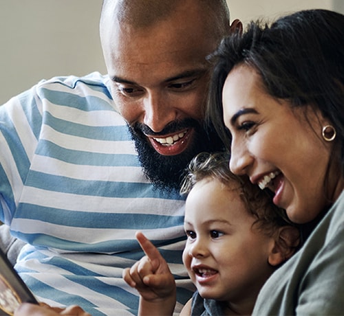 Young family looking at a tablet