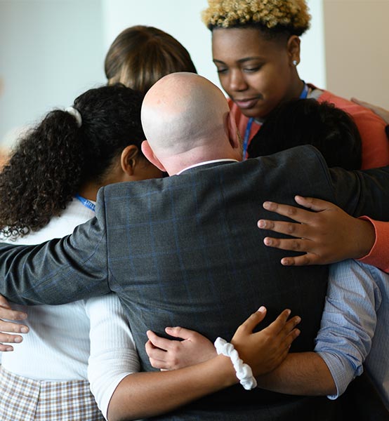 A group of people hugging together