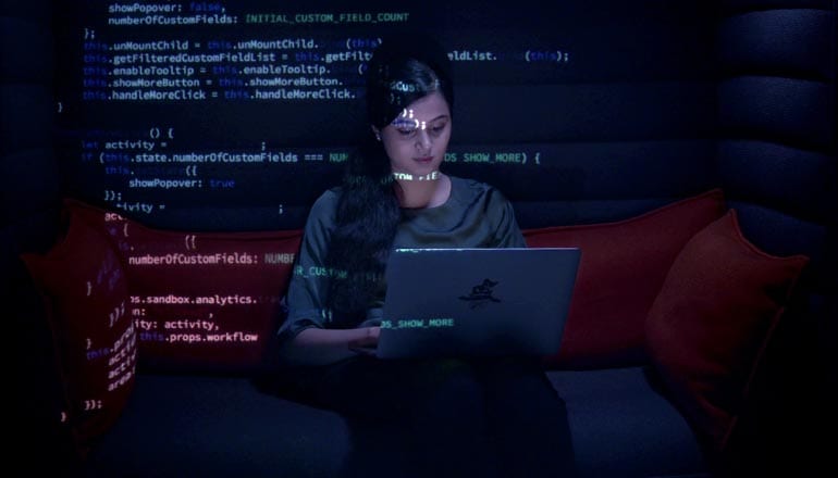 Intuit developer coding A woman sitting in front of her laptop writing codes