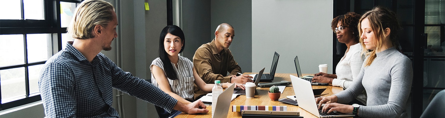 Diverse colleagues doing their work on a table