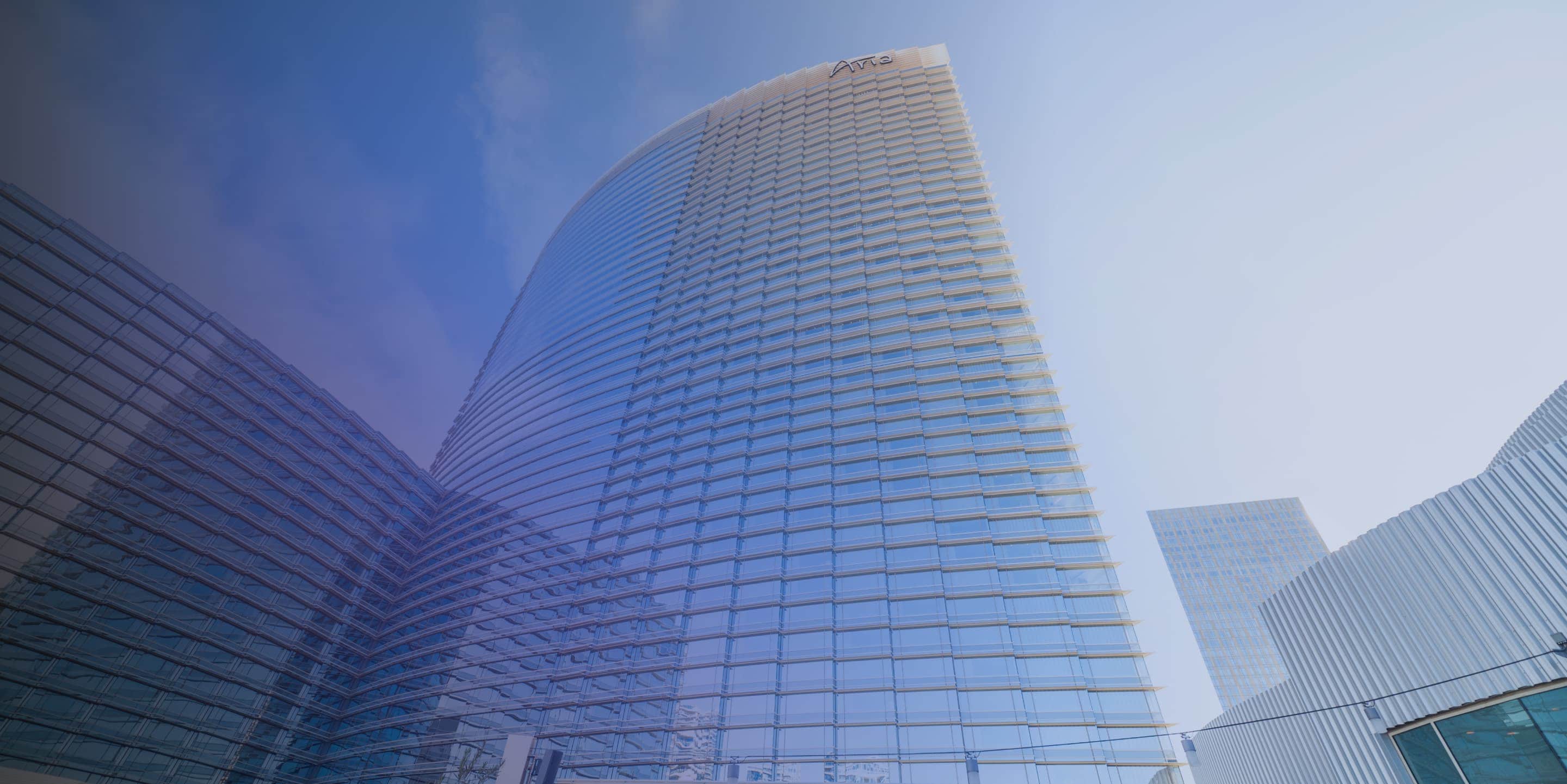 A view of a building with a blue sky behind it.