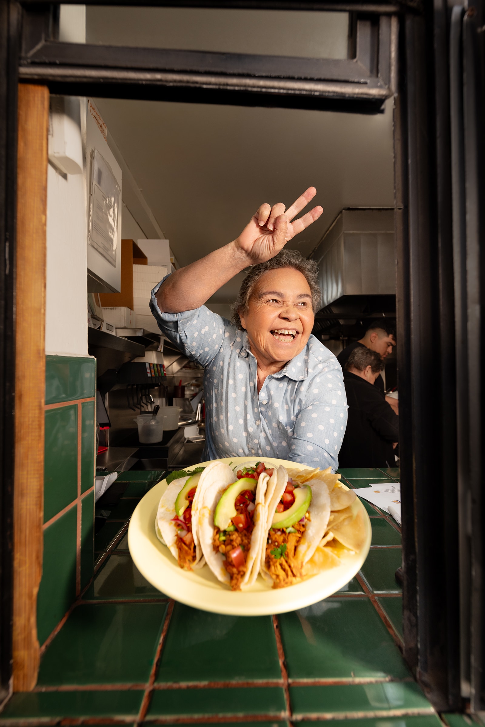 A person holding a plate of food in her hand.