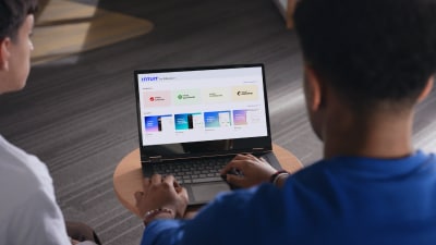 A student looking at the laptop, reading about Intuit products 