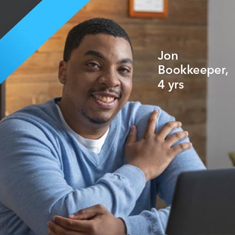 A person sitting in front of a computer keyboard.