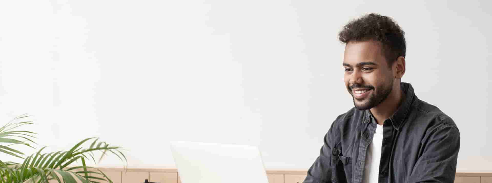 Male student using laptop at home