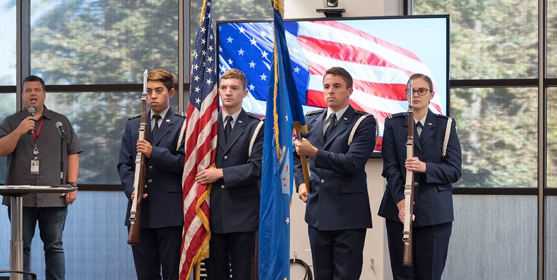 Military holding flag at Intuit meeting