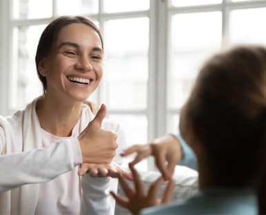 Mother and daughter communicating in sign language.