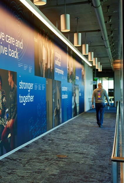 A person is walking with cell phone in his hand